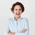 demo-attachment-878-happy-confident-woman-feeling-motivated-winking-smiling-standing-office-clothing-white-wall-1
